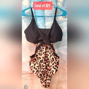 Crisscross front one piece swim suit with Open sides.